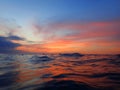 Colorful surface with vivid colors of sunset and night reflection before commencing of night dive. Royalty Free Stock Photo
