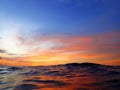 Colorful surface with vivid colors of sunset and night reflection before commencing of night dive. Royalty Free Stock Photo