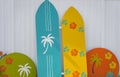 Colorful Surfboard on white background. Colored surfboards leaning up against a wooden fence Royalty Free Stock Photo
