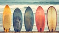 Colorful surfboards ready for waves on sunny beach next to sea with copy space for text placement