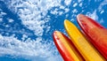 Colorful surfboards under clear blue sky, symbolizing the perfect summer vacation by the sea