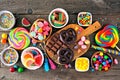 Colorful sweet candy buffet table scene, above view over rustic wood Royalty Free Stock Photo