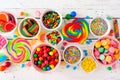 Colorful sweet candy buffet table scene, top view over white wood Royalty Free Stock Photo