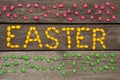 Colorful sweet candy on wooden background in text. Top view. Easter decor. Royalty Free Stock Photo