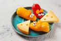 Colourful sweet mini peppers in the shape of mouses and pieces of cheese on a plate, stone table, snack for kids idea Royalty Free Stock Photo