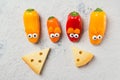 Colorful sweet mini peppers in the shape of mouses and pieces of cheese, stone table, top view, snack for kids idea