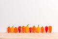 Colorful sweet peppers on wooden surface