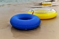 A colorful swim ring is placed on the beach