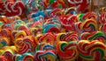 Colorful swirl lollipops at confectionery. Sweet candy for kids party. Candy day concept. Spiral rainbow color lollipops.