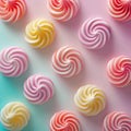 Colorful sweet swirled meringues on rainbow pastel gradient background, top view