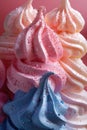 Colorful Swirled Meringues on Pink Background