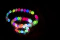 Colorful swirling spiral of bokeh lights at night