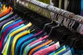 Colorful t-shirts hanging on second hand clothing market