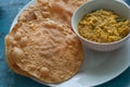 Colorful table with Indian food for breakfast. Papadum bread and vegetarian dal made from lentils or beans.