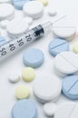 Colorful tablet and disposable syringe on white background