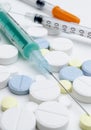 Colorful tablet and disposable syringe on white background