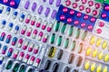 Colorful of tablets and capsules pill in blister packaging arranged with beautiful pattern with flare light. Pharmaceutical Royalty Free Stock Photo
