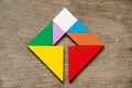 Colorful tangram puzzle in square with inside arrow direction