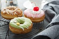 Colorful tasty donuts on a cooling rack