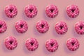 Colorful tasty donuts on pink background. Royalty Free Stock Photo