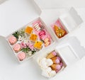 Colorful tasty sweets in opened white windowed boxes. Top view