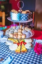 Colorful Tea party with table laid out fancy tea cups and saucers, with sweet and savoury foods Royalty Free Stock Photo