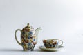 Colorful teapot and cup on a white background