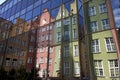 Colorful tenement houses reflected in windows of modern building in Gdansk Royalty Free Stock Photo