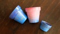 Colorful terracotta pots painted in blue and pink arylic paints. Royalty Free Stock Photo