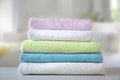 Colorful terry towels stack on table indoors. Bathroom shower items. Household Royalty Free Stock Photo