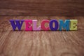 Colorful text welcome letters alphabet on wooden background