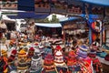 Colorful textile stall with hats in the popular