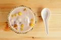 Colorful thai dessert `bua loy or bua Loi` Contains coconut milk, glutinous rice powder with poached egg, on wooden Royalty Free Stock Photo