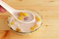 Colorful thai dessert `bua loy or bua Loi` Contains coconut milk, glutinous rice powder with poached egg, on wooden Royalty Free Stock Photo