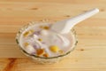 Colorful thai dessert `bua loy or bua Loi` Contains coconut milk, glutinous rice powder with poached egg, on wooden Royalty Free Stock Photo