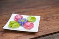 Colorful Thai layer cake in flower shape on wood table background