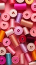 Colorful thread spools and buttons on pink background, top view Royalty Free Stock Photo