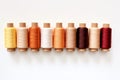 Colorful Thread Spools in Closeup Shot, Showcasing Multi-Color Bobbins on White Background, Generative AI