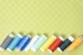 Colorful thread in spools on green background Royalty Free Stock Photo