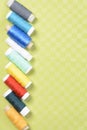 Colorful thread in spools on green background Royalty Free Stock Photo