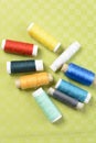 Colorful thread in spools on green background Royalty Free Stock Photo
