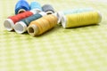 Colorful thread in spools on green background Royalty Free Stock Photo