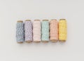 Colorful Thread Spools in a Row on White Table â Sewing and Craft Concept Royalty Free Stock Photo