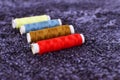 Colorful thread spools used in fabric and textile industry. Multicolor sewing threads. Blurry, selective focus Royalty Free Stock Photo
