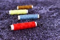 Colorful thread spools used in fabric and textile industry. Multicolor sewing threads. Blurry, selective focus Royalty Free Stock Photo