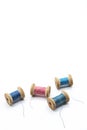 Colorful threads for sewing. Different threads on wooden vintage reels Royalty Free Stock Photo