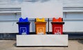 Colorful three bins for separate trash for reuse and disposal at park. Trashcan for dumping used stuff or material