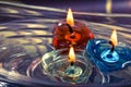 Colorful three candles floating on water aroma bowl,retro Royalty Free Stock Photo