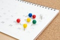 Colorful thumbtack, pushpin or pins on calendar concept for busy meeting schedule, reminder or special event and important Royalty Free Stock Photo