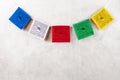 Colorful Tibetan buddhist prayer flags by Nepal on a grey background, copy space Royalty Free Stock Photo